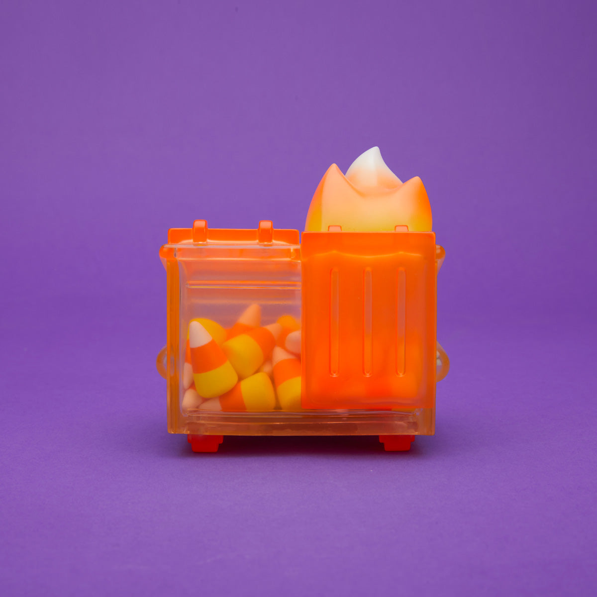 Orange translucent Dumpster Fire filled with candy corn and a yellow, orange, and white flame from the back.