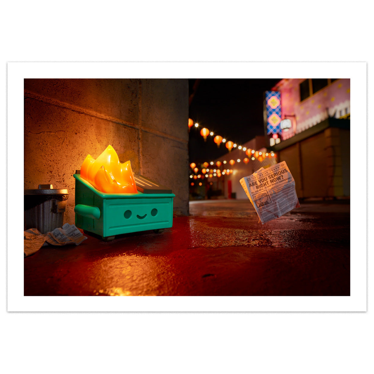 A photo of the Dumpster Fire in an ally with the flame lit up and a small news paper flying away which reads Are You Serious Right Now?