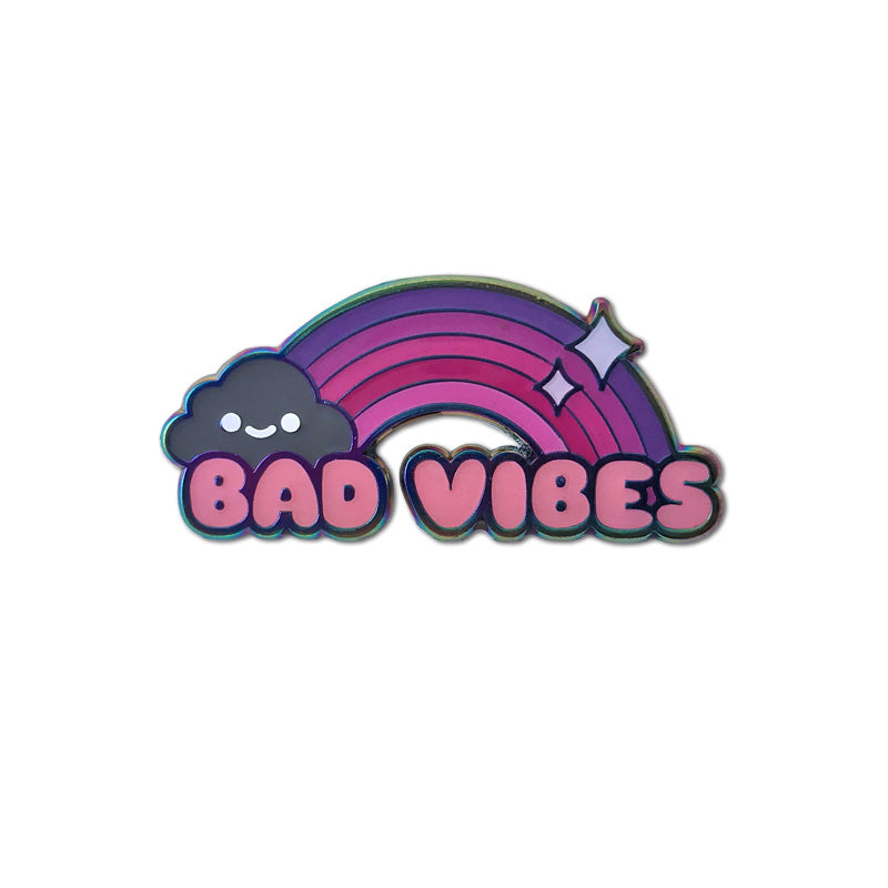 A pin of a pink and purple rainbow with a grey cloud at the end and Bad Vibes written under it. 