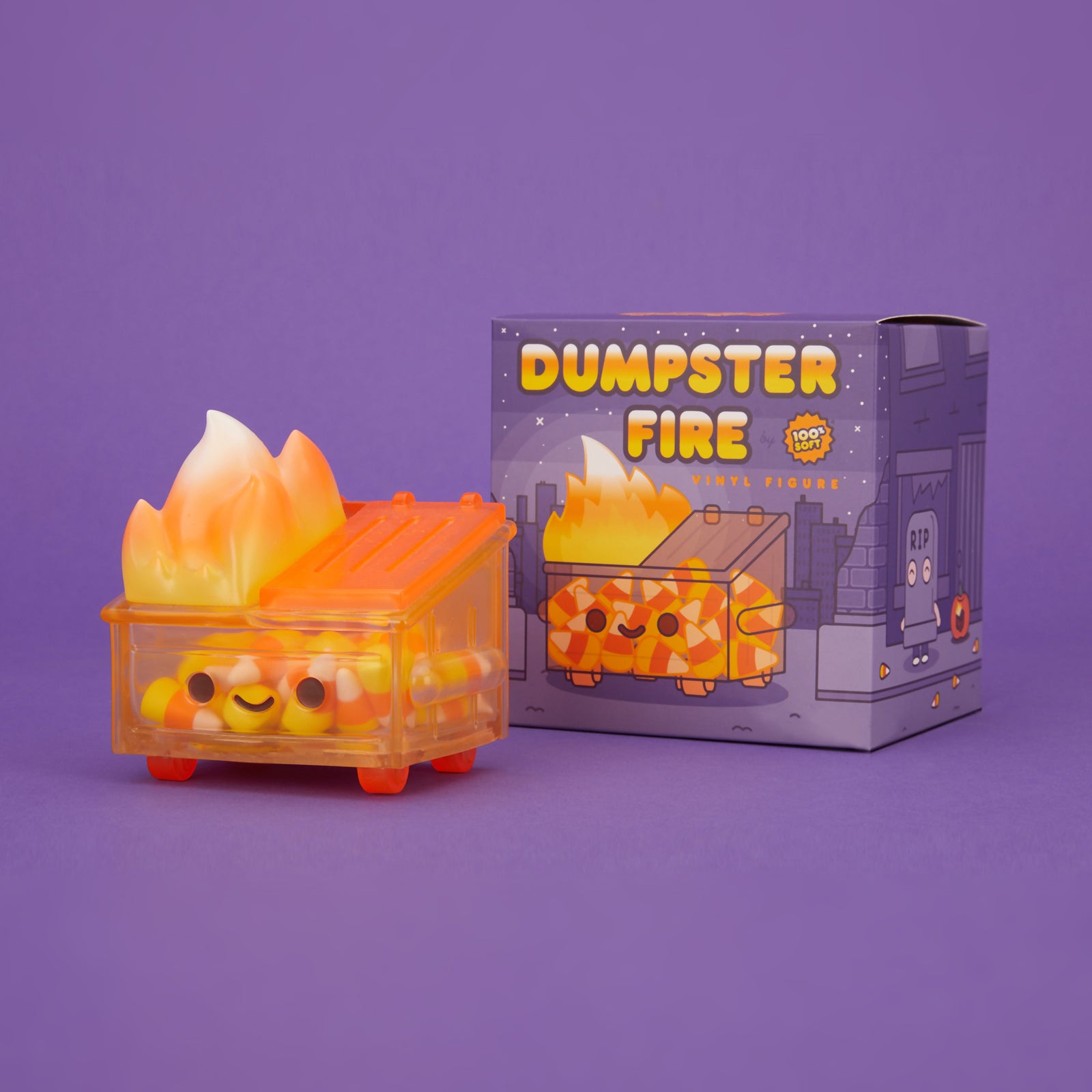 Orange translucent Dumpster Fire filled with candy corn and a yellow, orange, and white flame, pictured with its box.