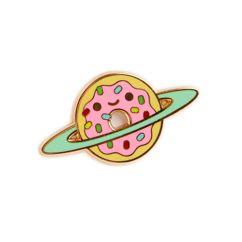 A pin of donut with pink frosting and sprinkles on it that is smiling with a blue ring around it like a planet.