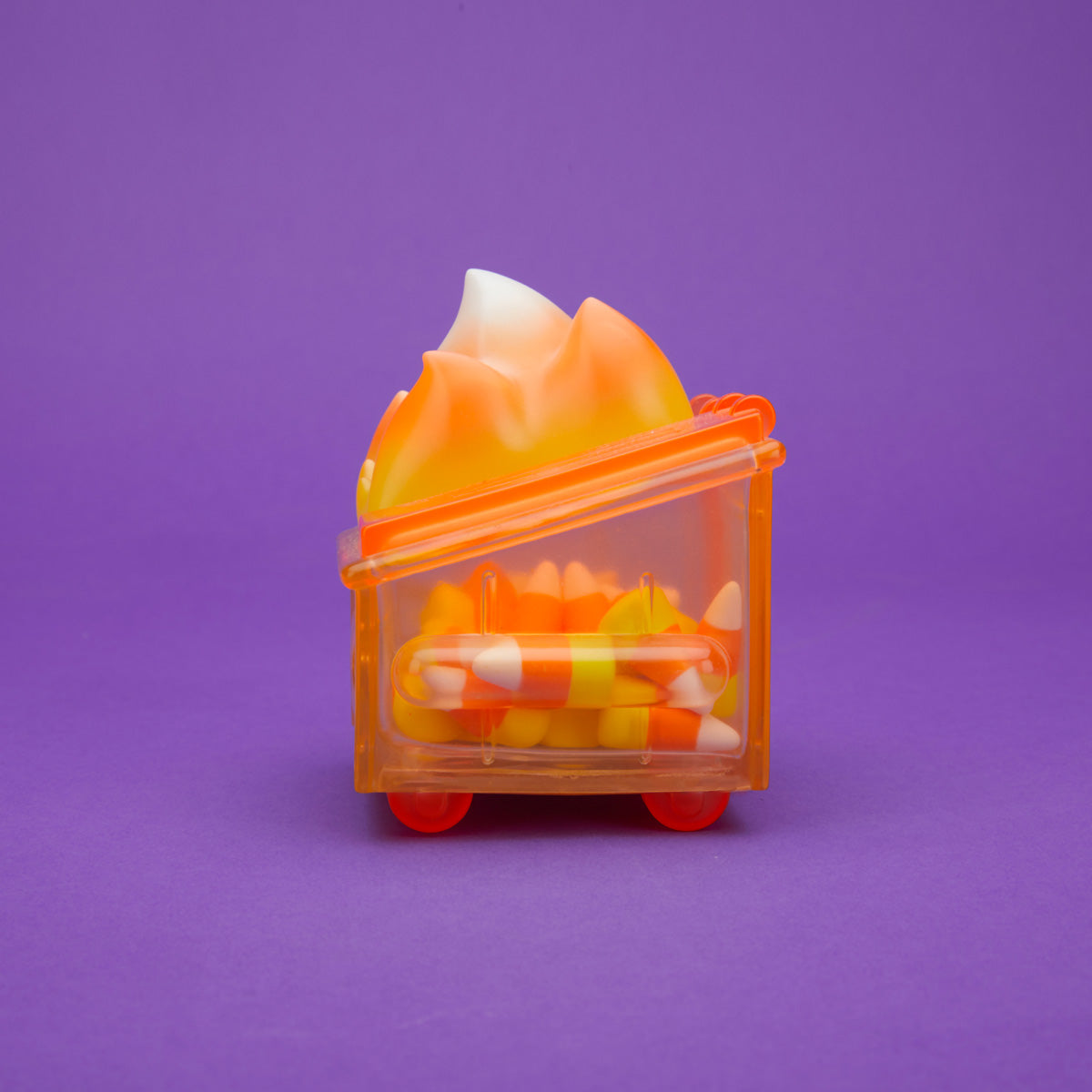 Orange translucent Dumpster Fire filled with candy corn and a yellow, orange, and white flame from the side.