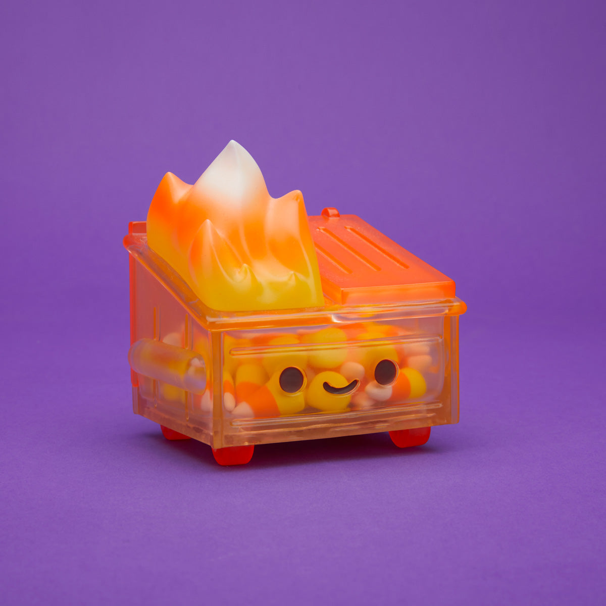 Orange translucent Dumpster Fire filled with candy corn and a yellow, orange, and white flame from the side.