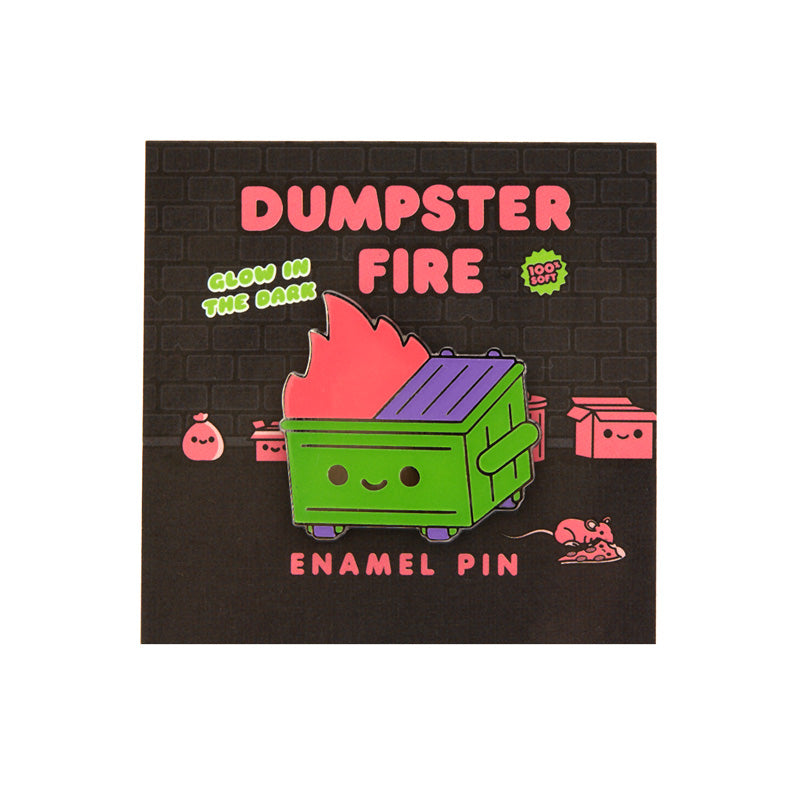 A green and purple dumpster fire pin with pink flames on its card backing. 