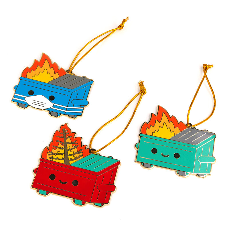 Three different dumpster fire orniments; Original, PPE edition, and Holiday Inferno. They are all pictured hanging on a Christmas tree. 